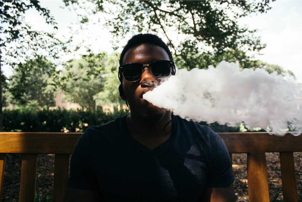 man exhaling smoke